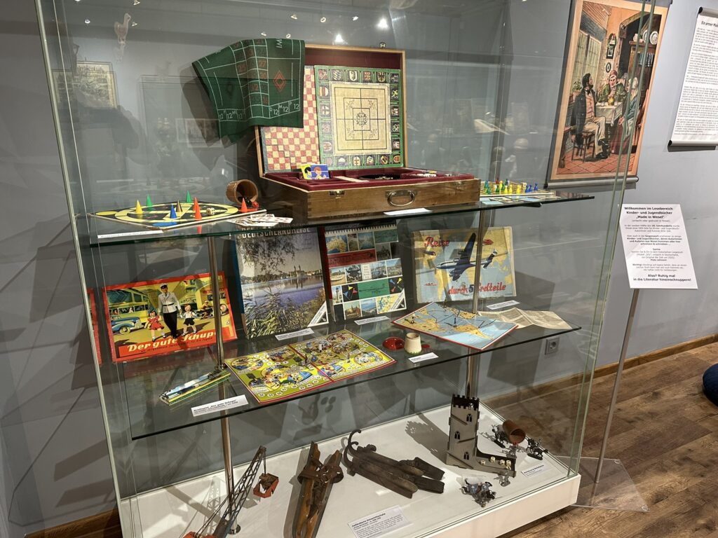 Mehrere alte Brettspiele in einer Vitrine